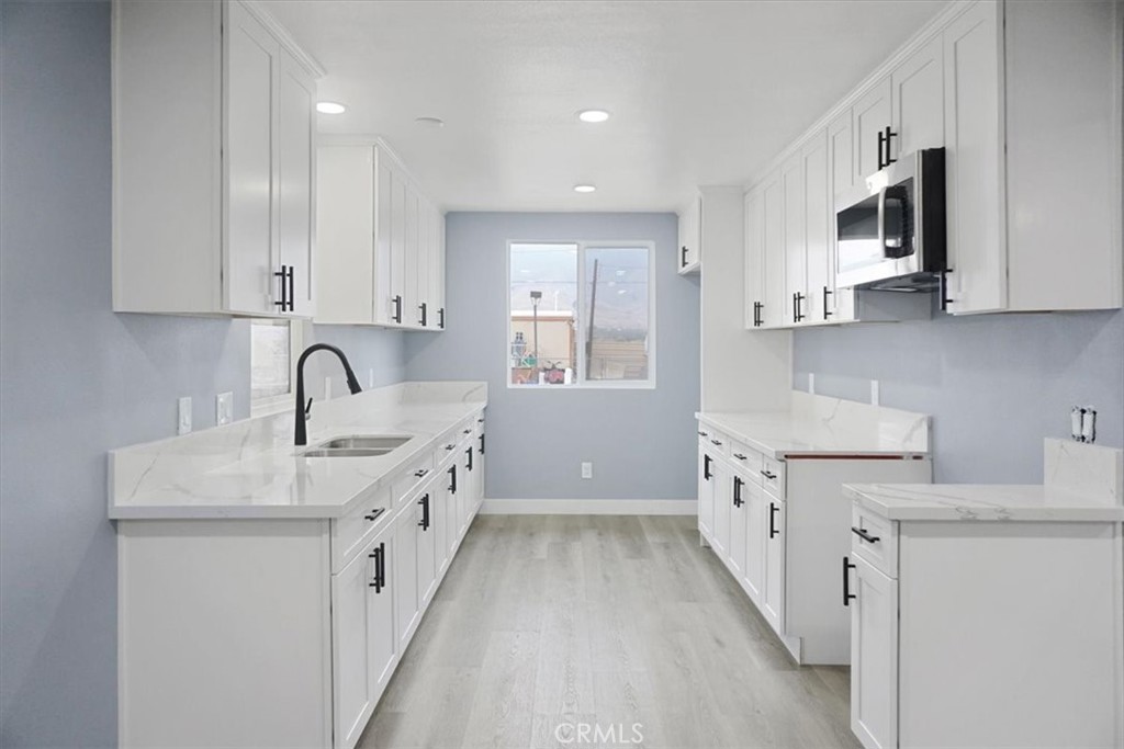 a kitchen with cabinets a sink and appliances