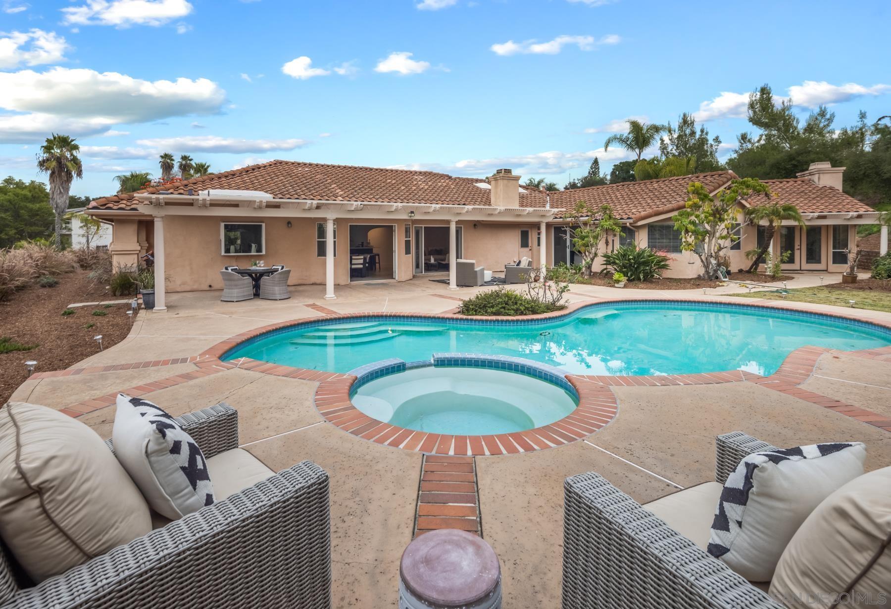 a view of a house with swimming pool and porch