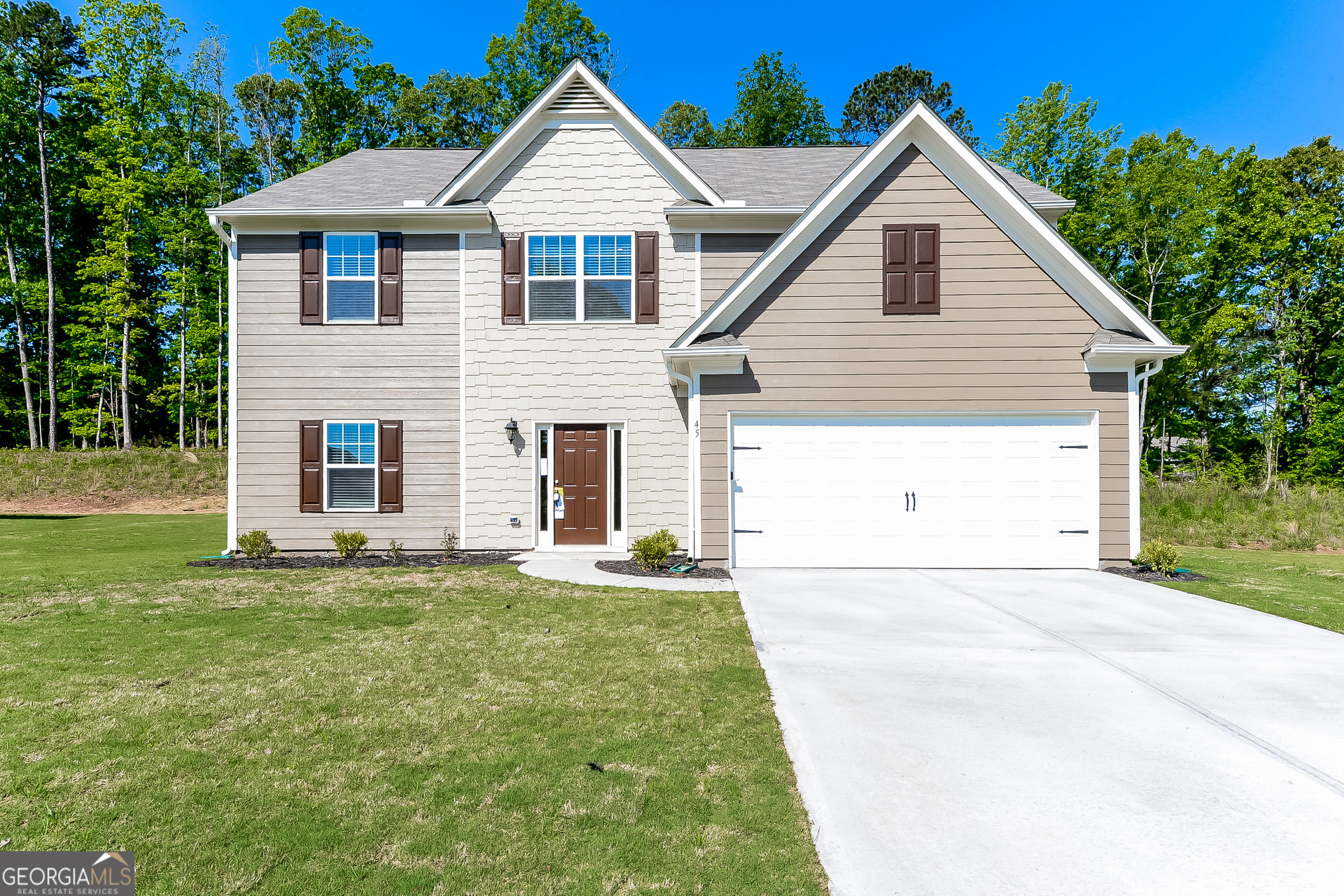 a view of a yard in front view of a house