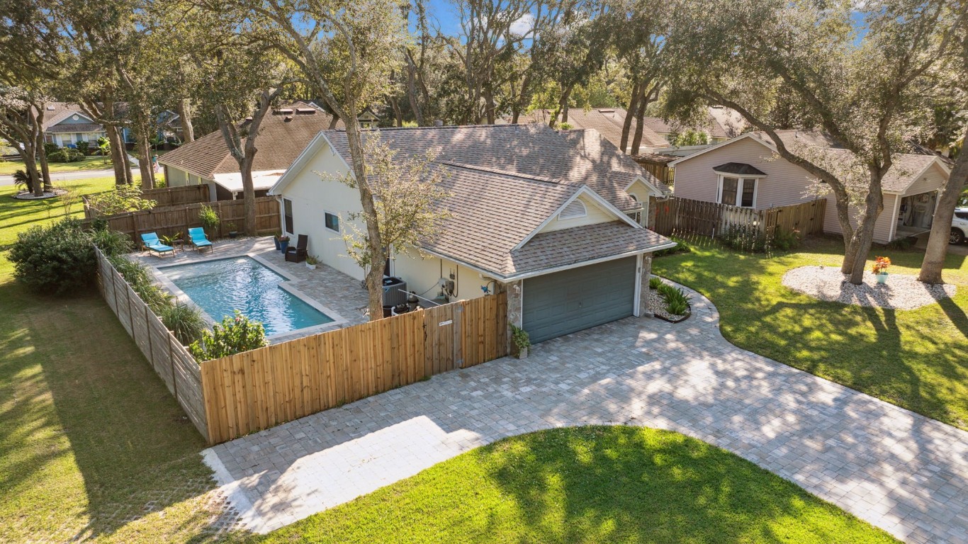 a view of a couches in the patio next to a yard