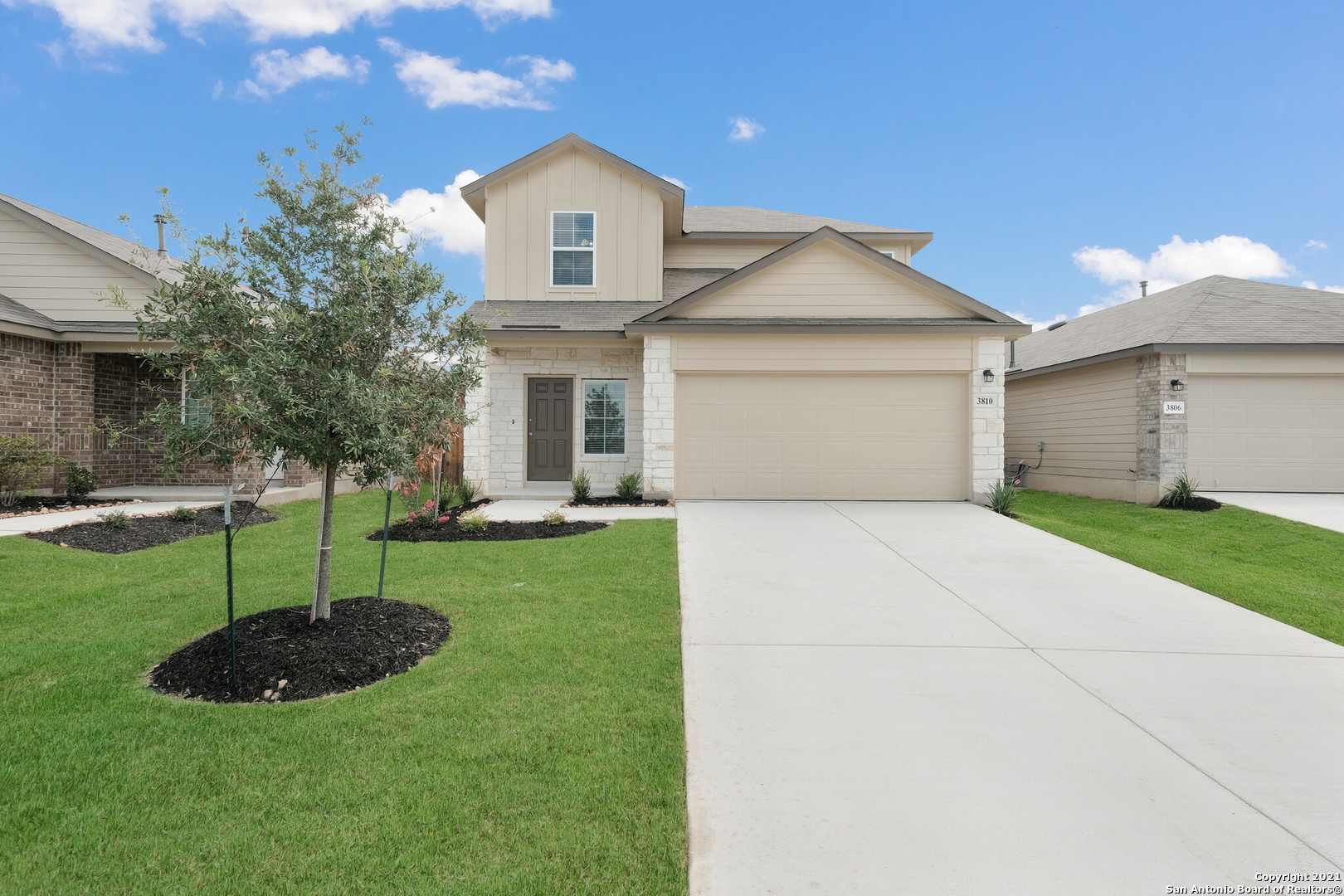 a front view of a house with a yard and garage