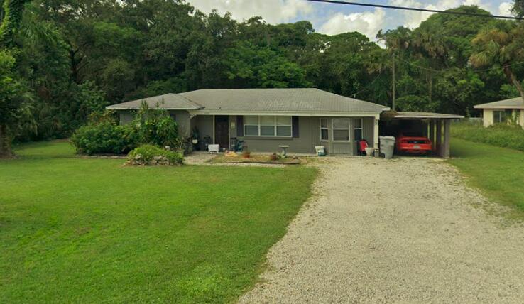 a view of a house with backyard porch and sitting area