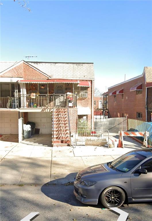 a view of a balcony and car parked