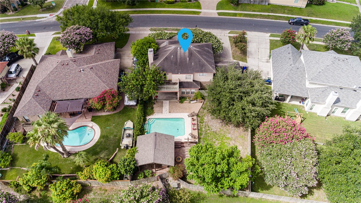 an aerial view of a house with garden space and street view