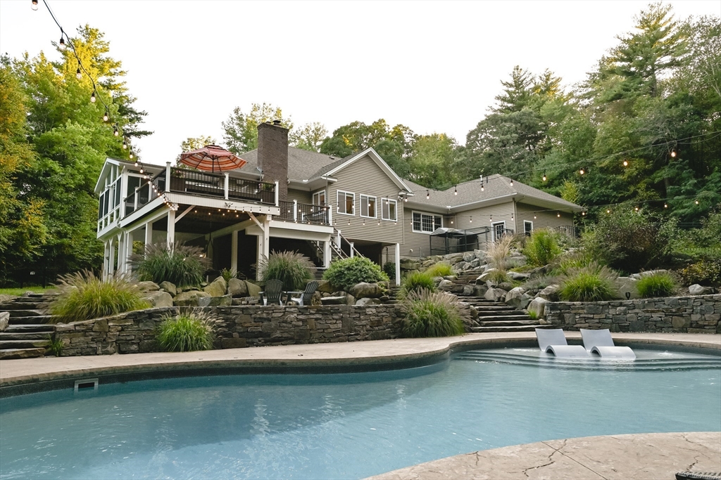 a front view of a house with a yard and swimming pool