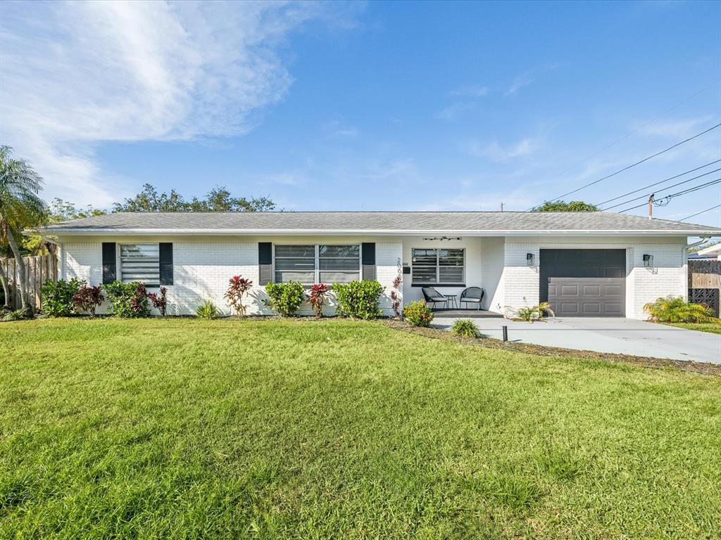 front view of a house with a patio and a yard