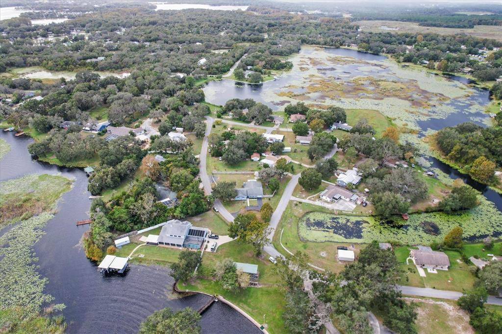 an aerial view of residential houses with outdoor space and parking