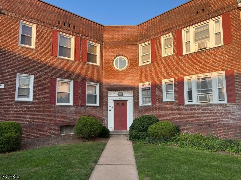 a view of a brick building with a yard