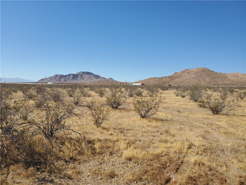 a view of a mountain range with trees in the background