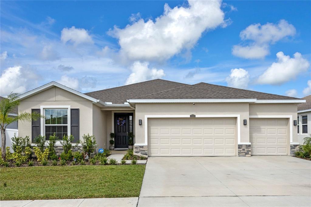 a front view of a house with a yard and garage