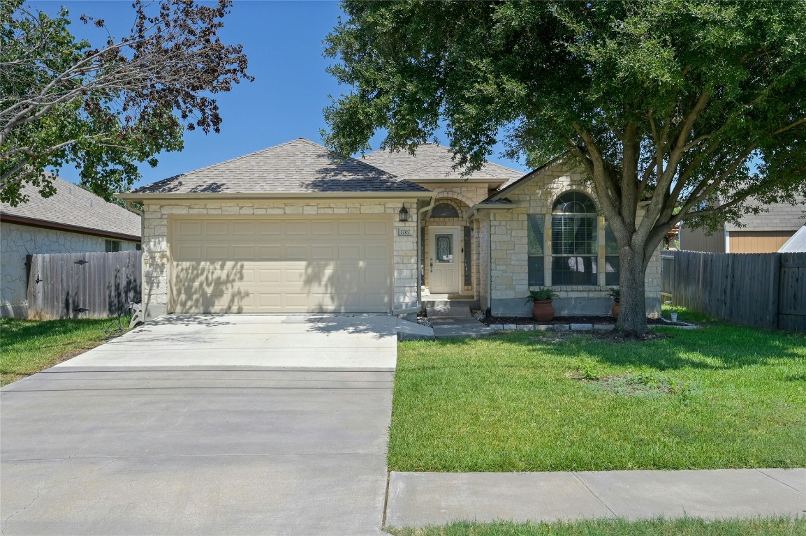 a front view of house with yard and green space