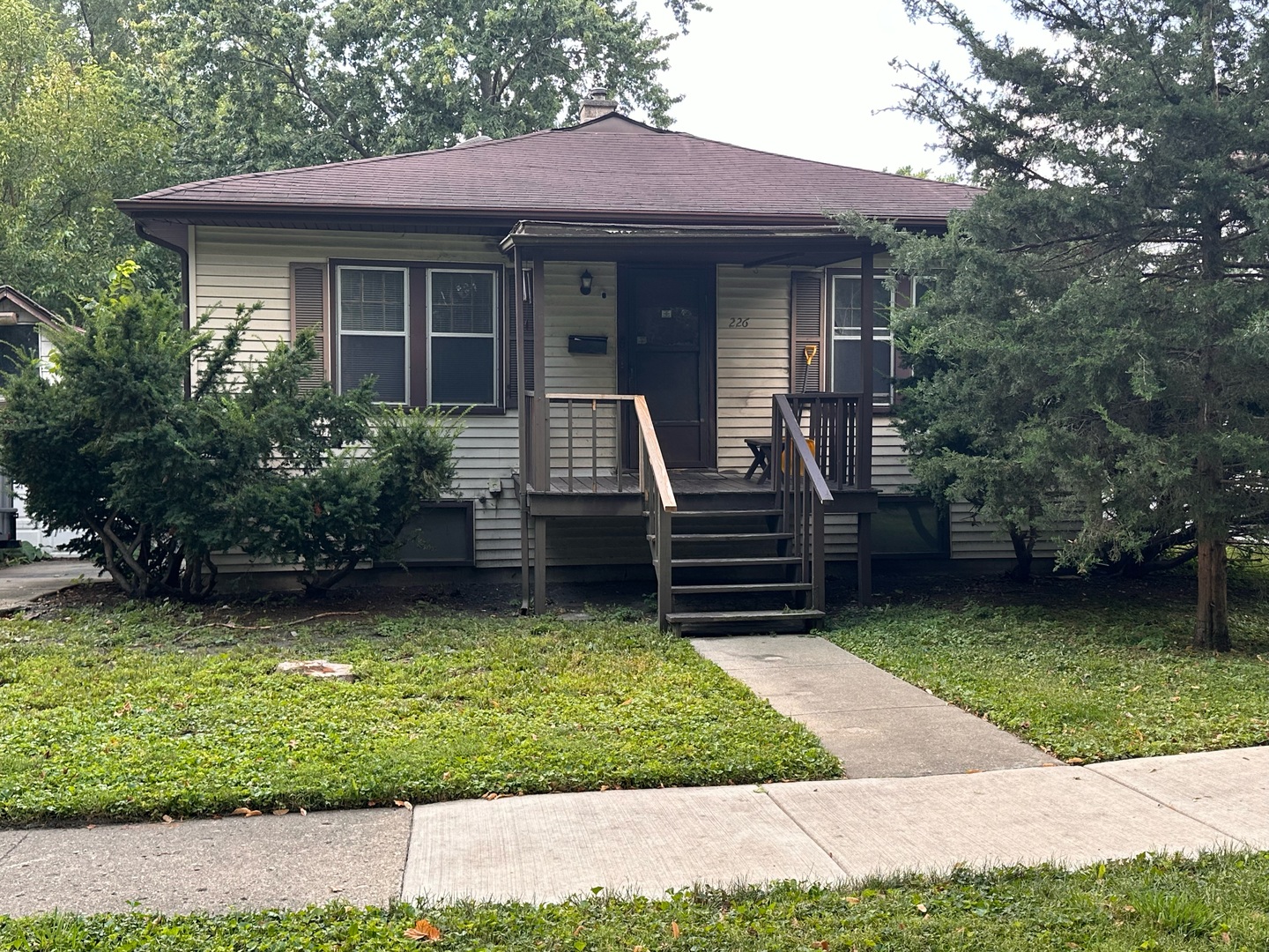 a view of a house with a yard porch and sitting area