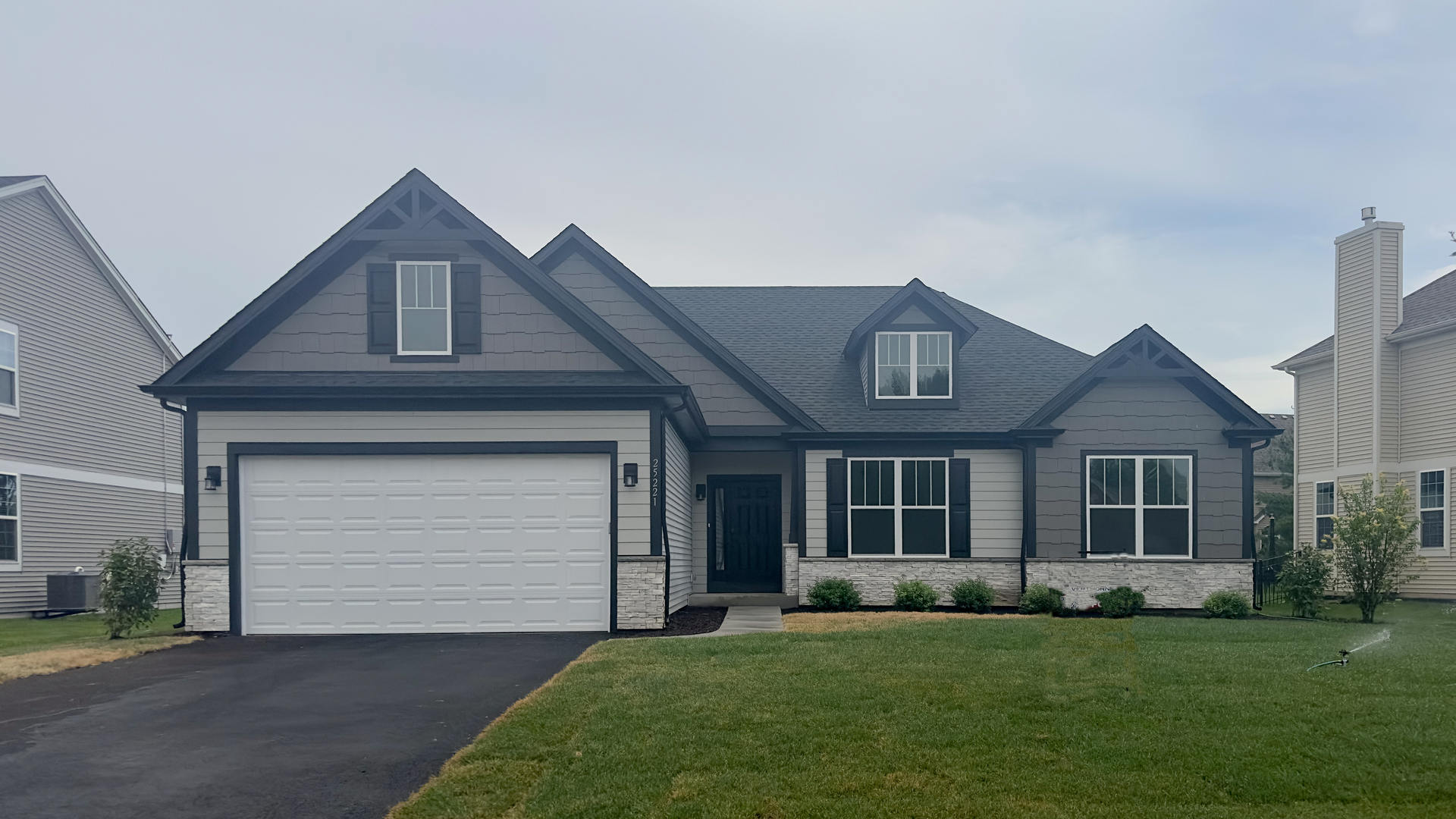 a front view of a house with a garden