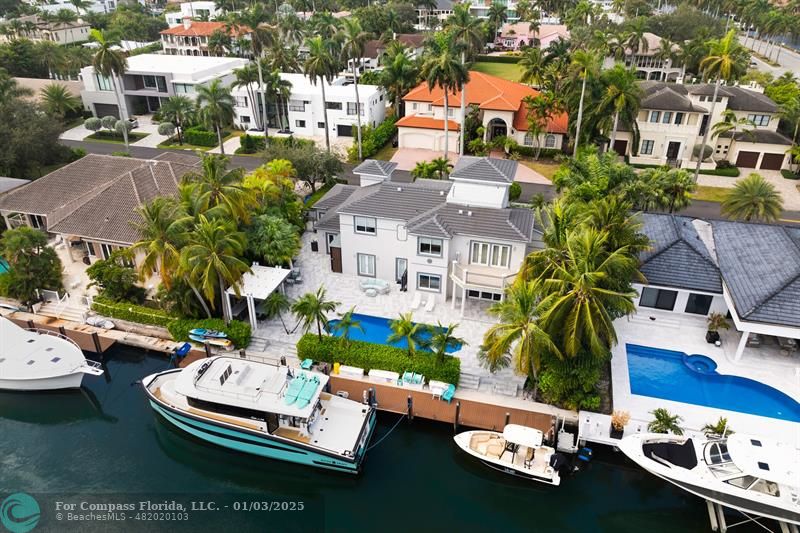 an aerial view of a house with a garden and swimming pool