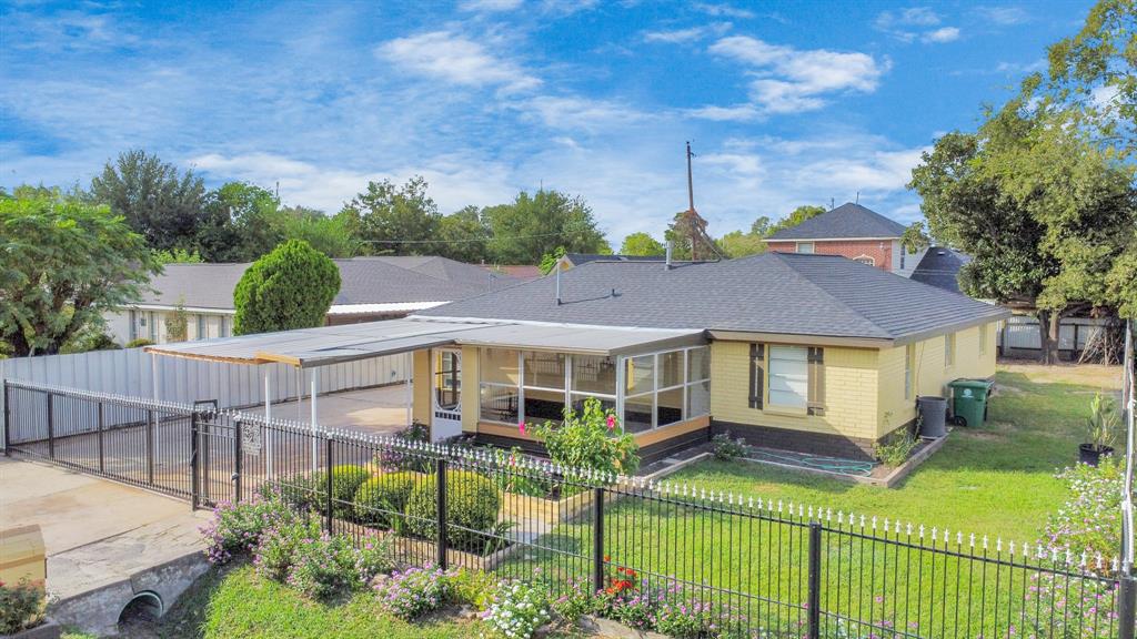 a view of a house with wooden fence