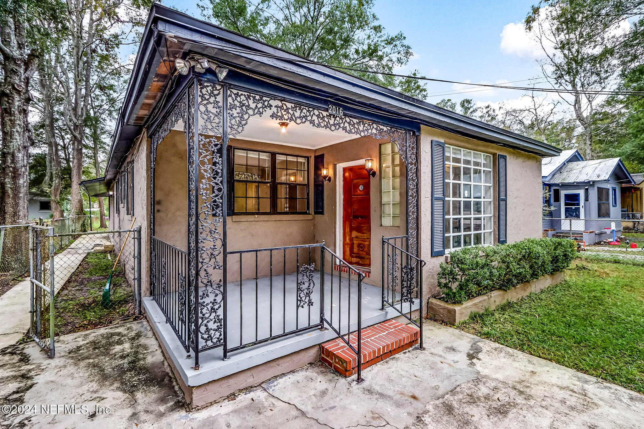 a view of house with a patio and wooden fence