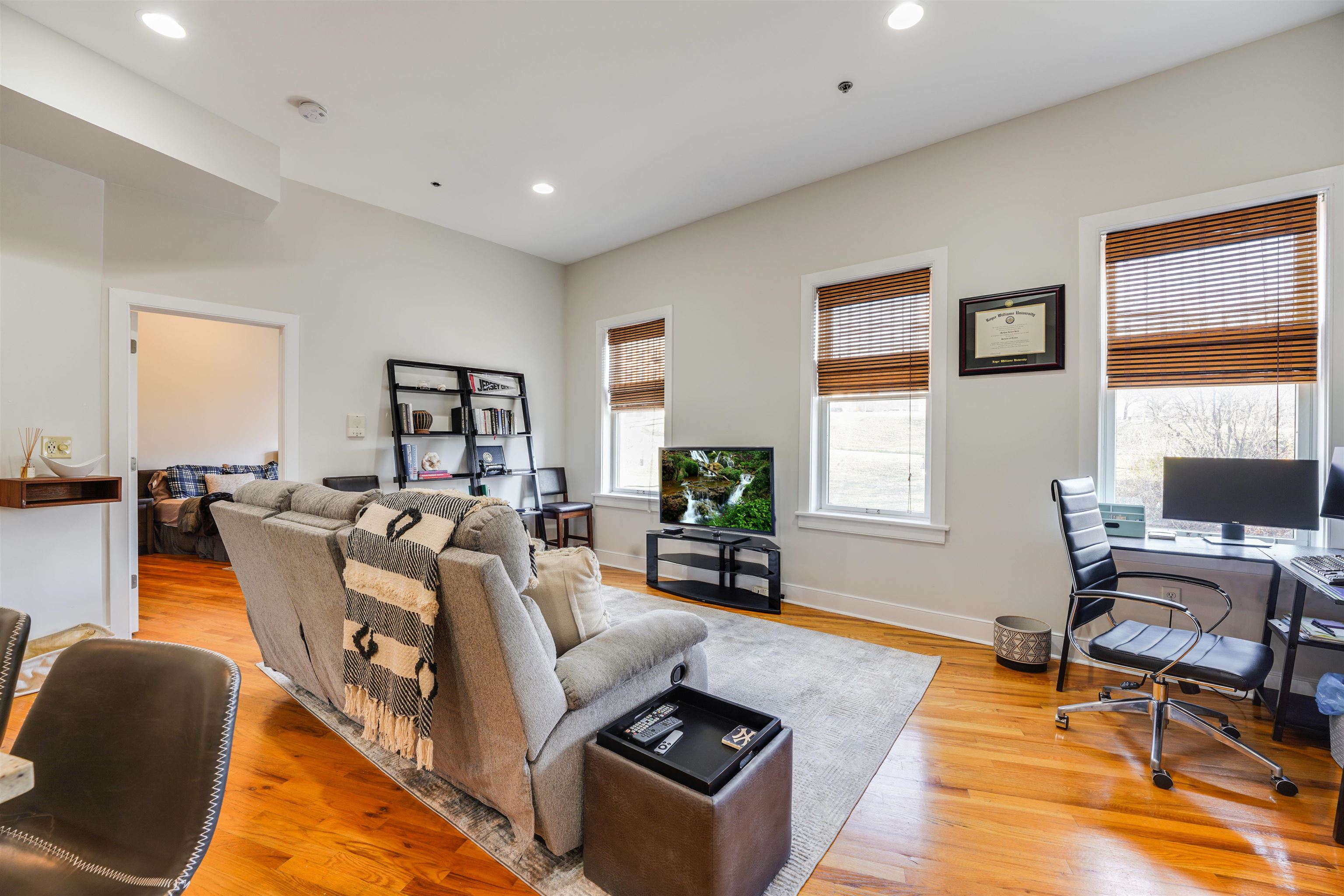 a living room with furniture window and a flat screen tv