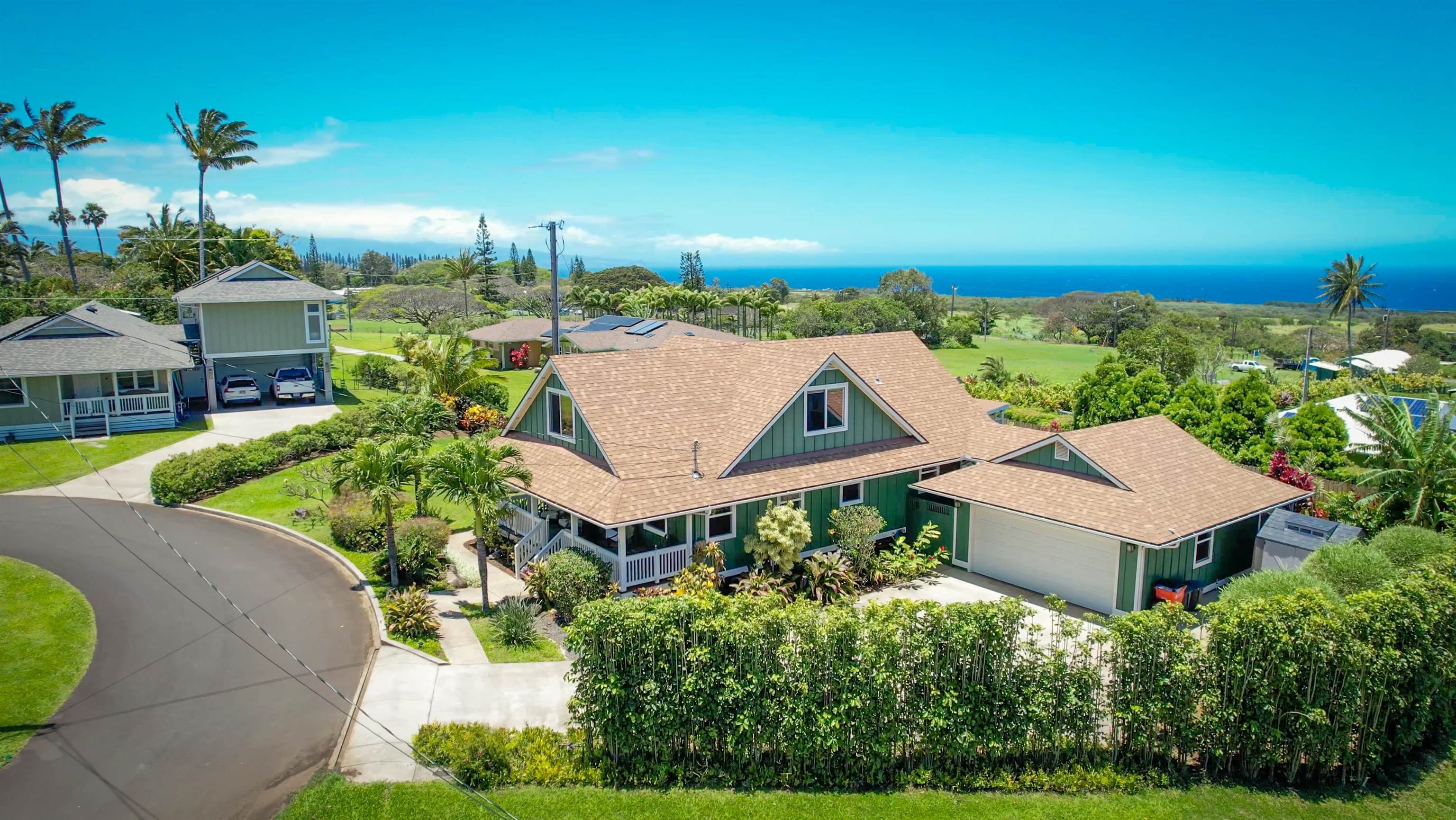 an aerial view of a house with a garden and lake view