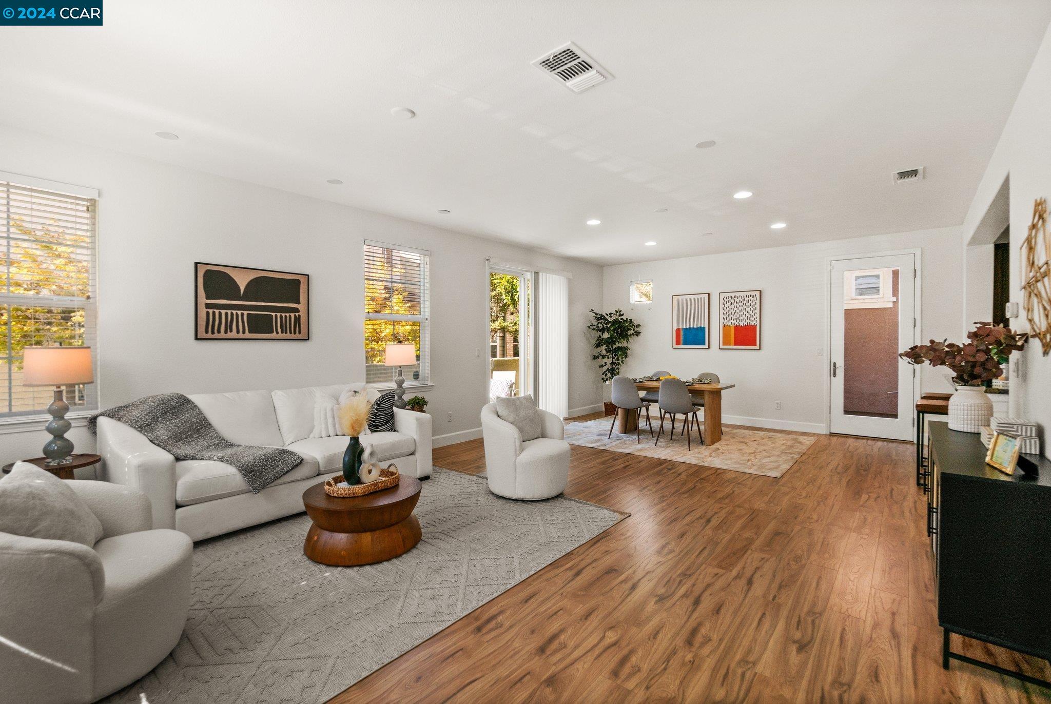 a living room with furniture and wooden floor