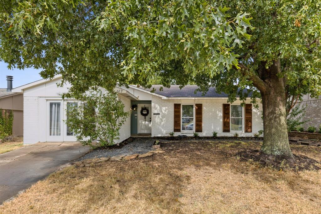 front view of a house with a tree