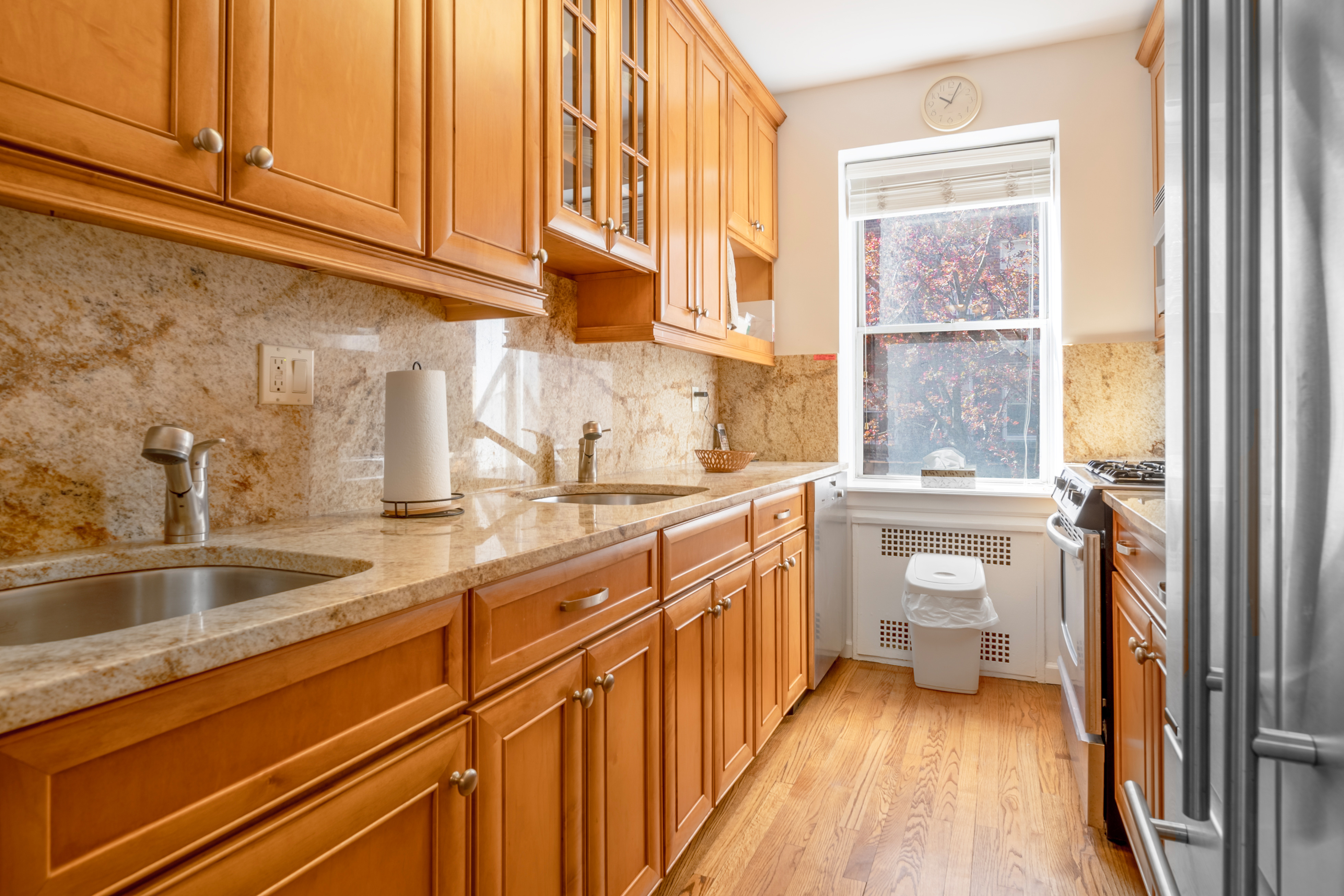 a kitchen with granite countertop a sink a stove and cabinets