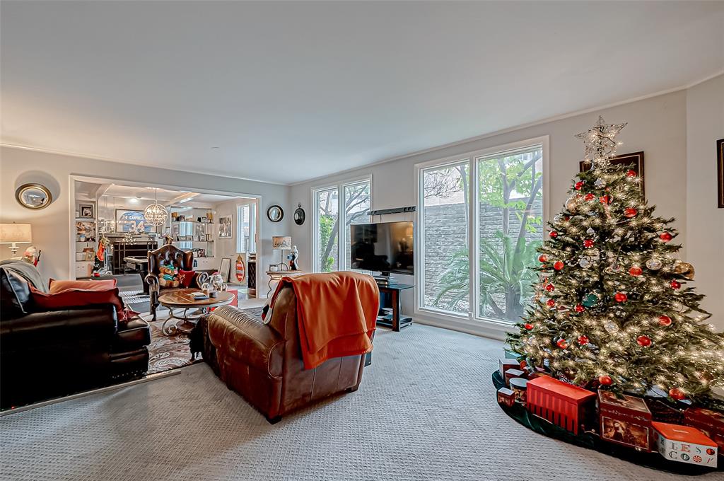 a living room with furniture a flat screen tv and a large window