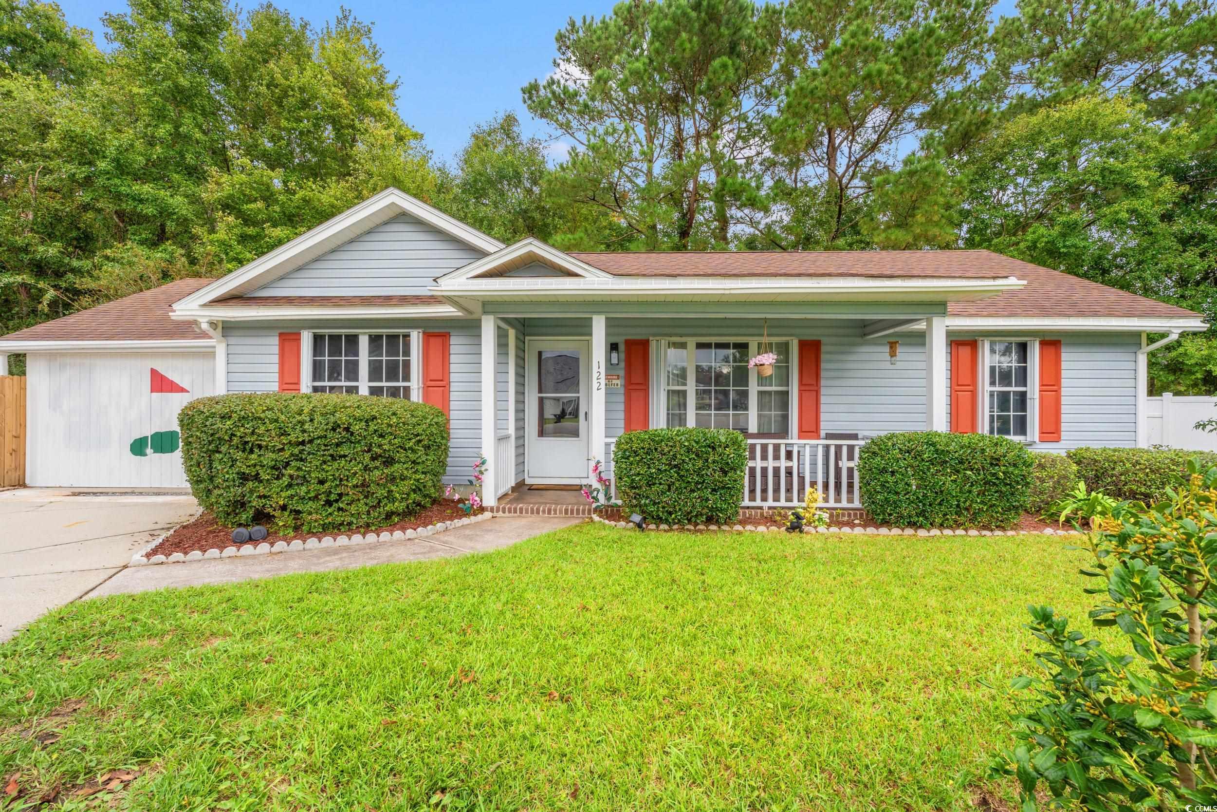 Ranch-style home with covered porch and a front ya