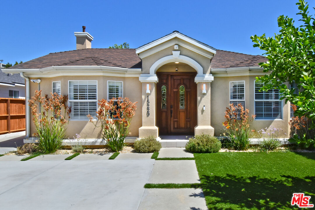 front view of a house with potted plants