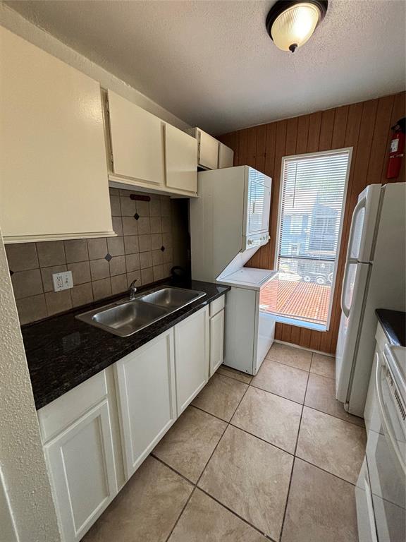 a kitchen with a sink a stove and cabinets