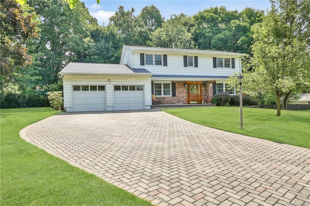 View of front property with a front lawn and a garage