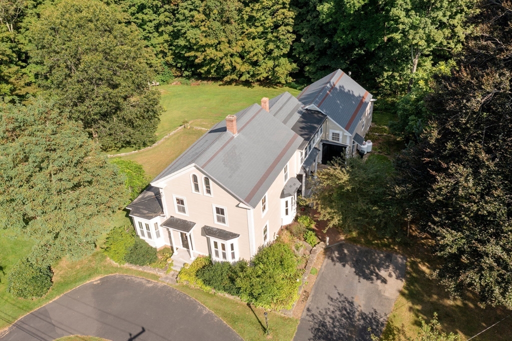 an aerial view of a house with a yard