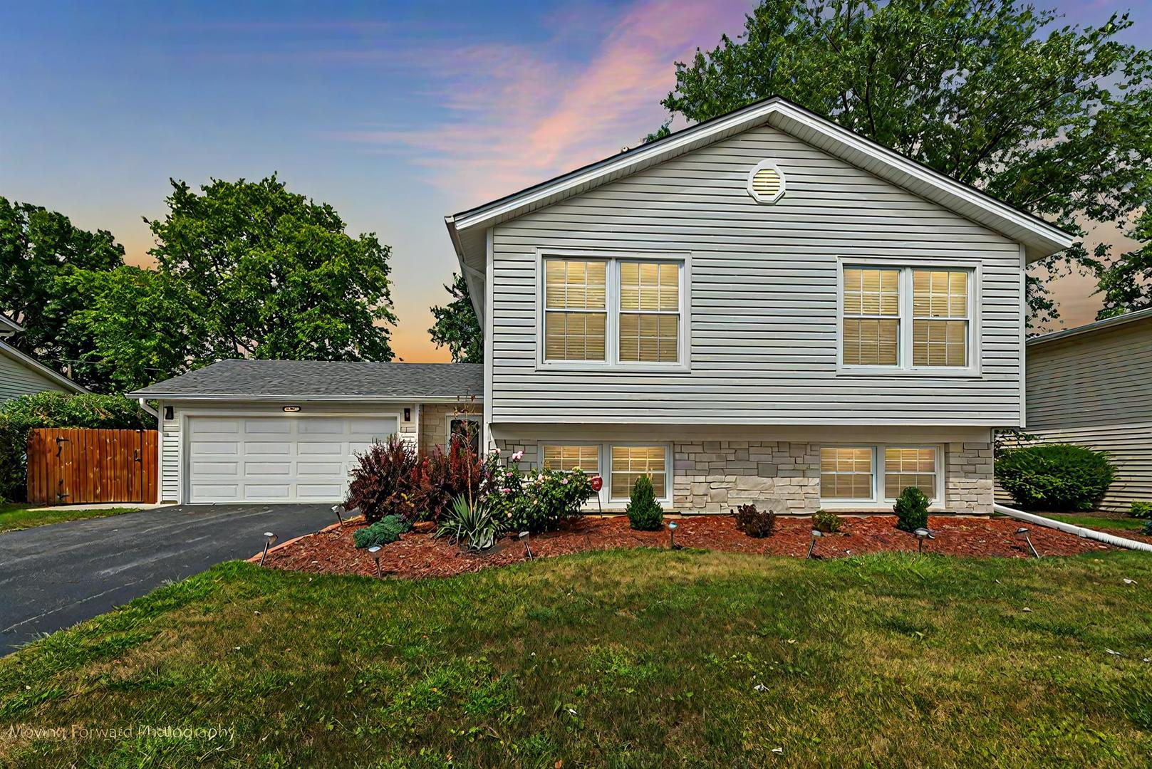 a front view of house with yard and green space