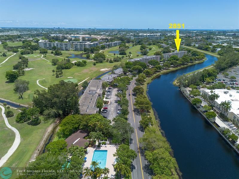 an aerial view of residential houses with outdoor space and river