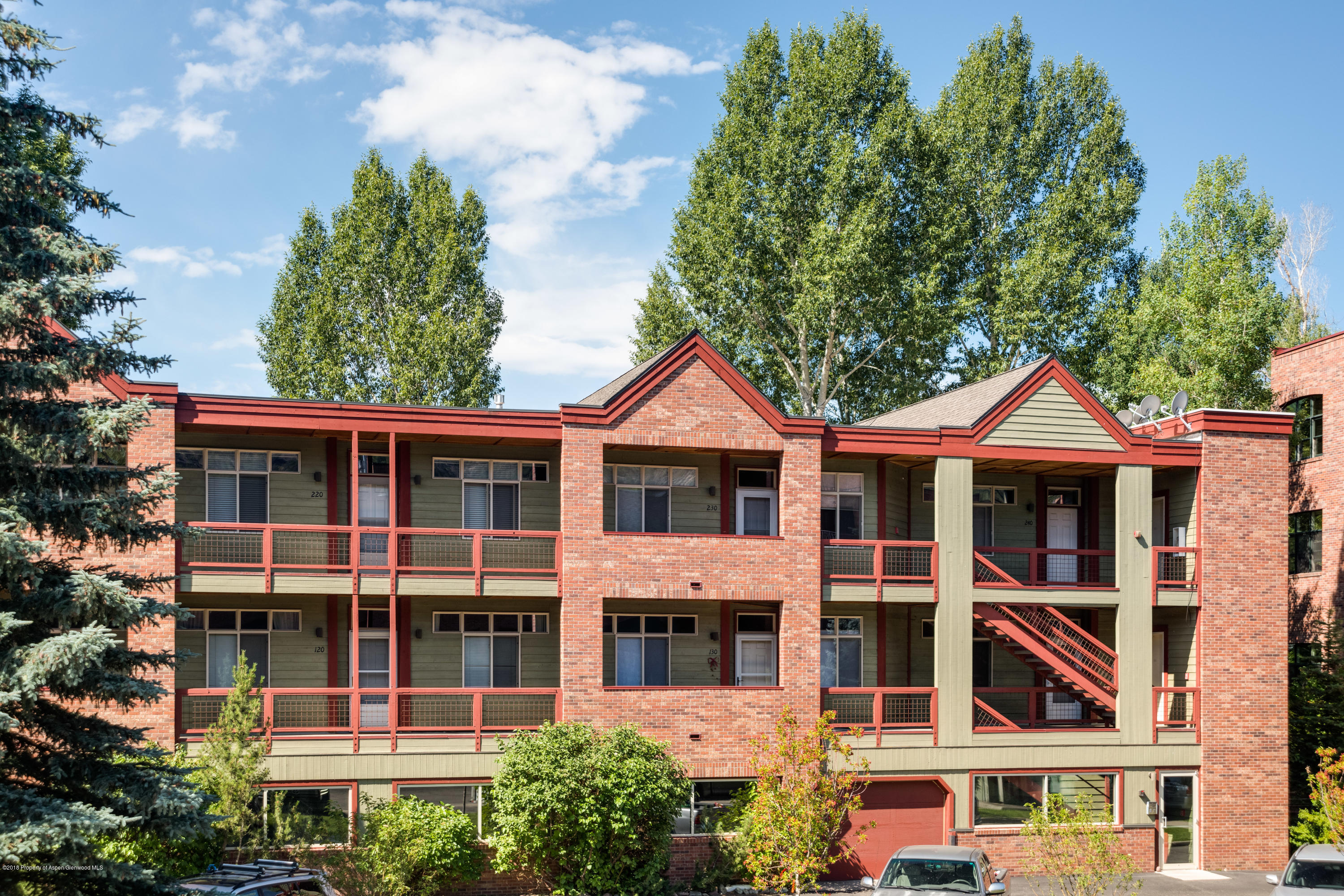 a front view of a residential apartment building with a yard