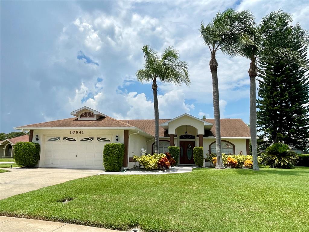 a front view of a house with garden