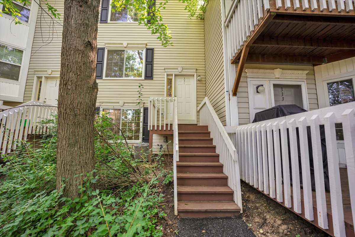 a view of a house with wooden fence