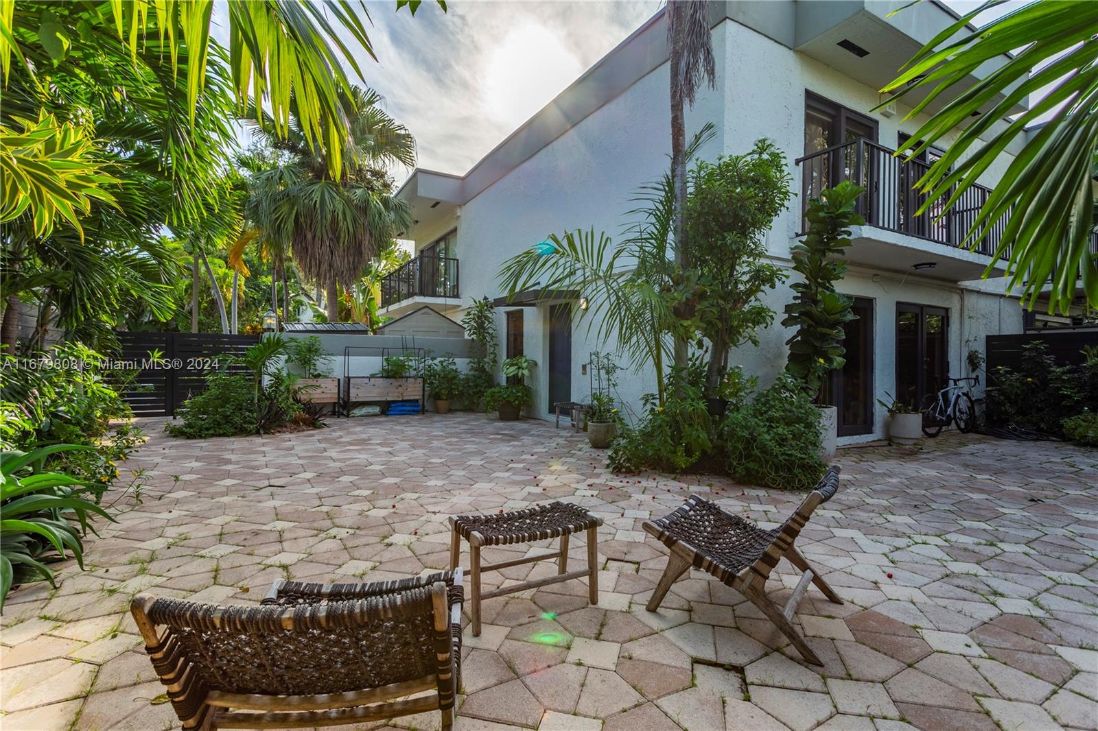 a view of a backyard with plants and a patio