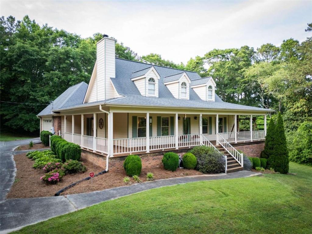 a front view of a house with a garden and porch