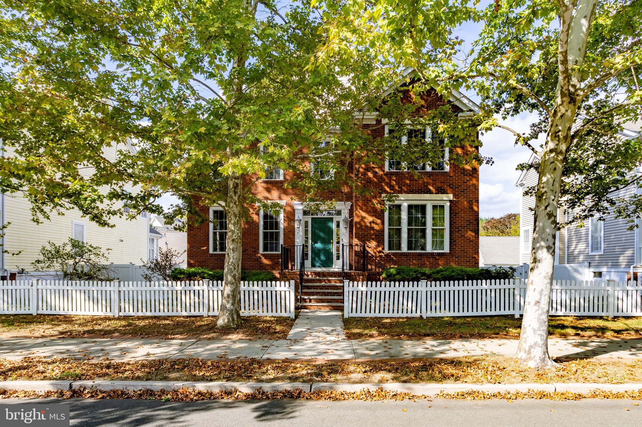 a view of a house with a tree in front