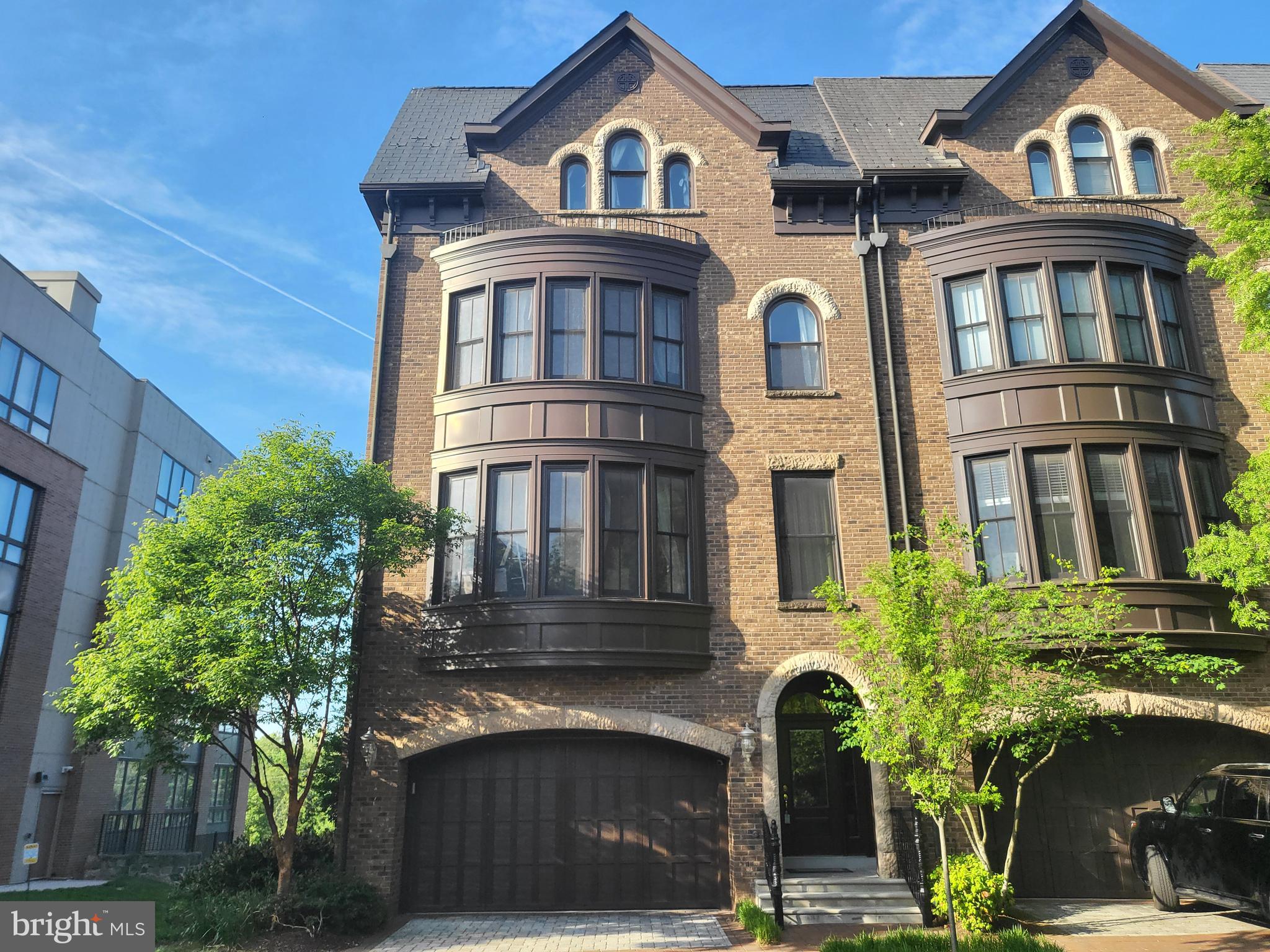 a front view of a residential apartment building with a yard