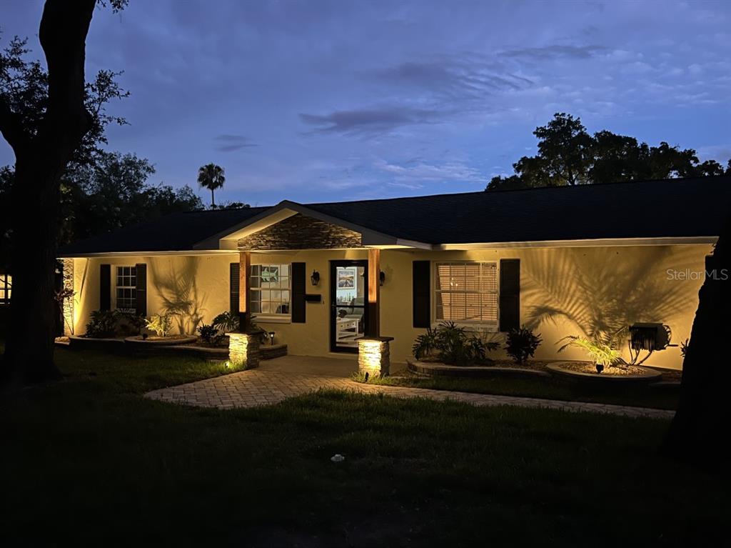 a front view of a house with sitting area