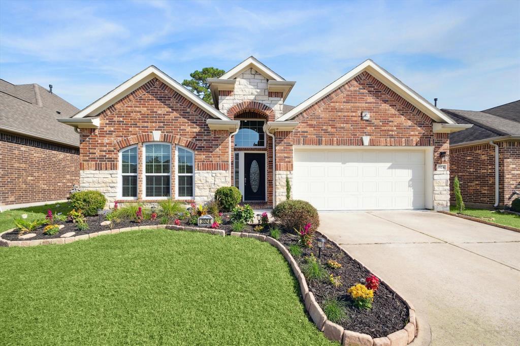 BEAUTIFUL CURB APPEAL WITH LANDSCAPING AND BRICK AND STONE FRONT ELEVATION.