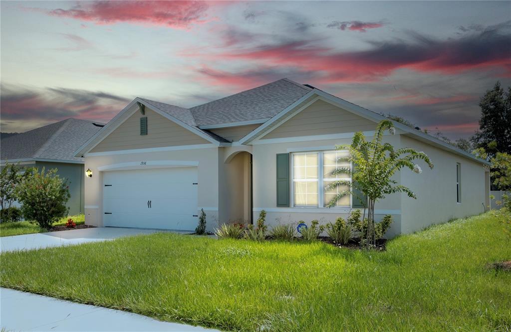 a front view of house with yard and green space