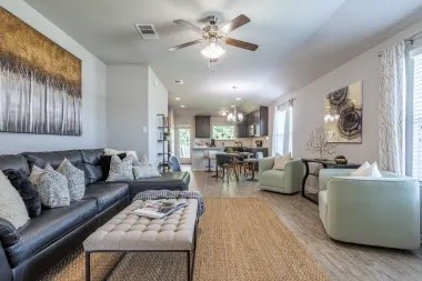 a living room with furniture and a chandelier