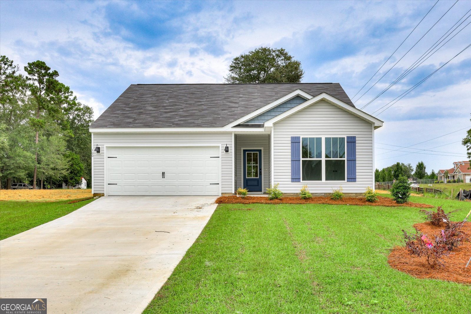 a front view of a house with a yard and garage