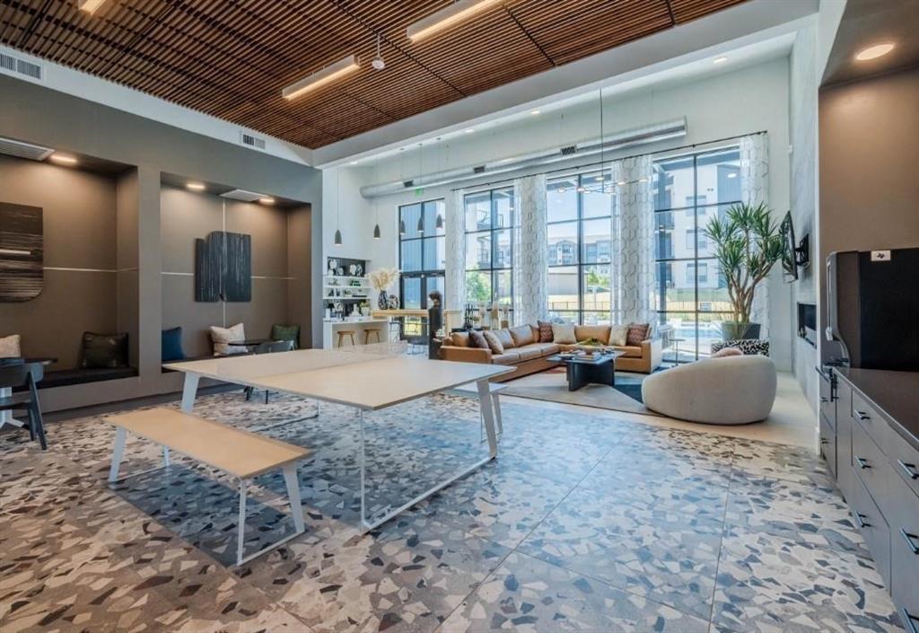 a living room with furniture a flat screen tv and a large window