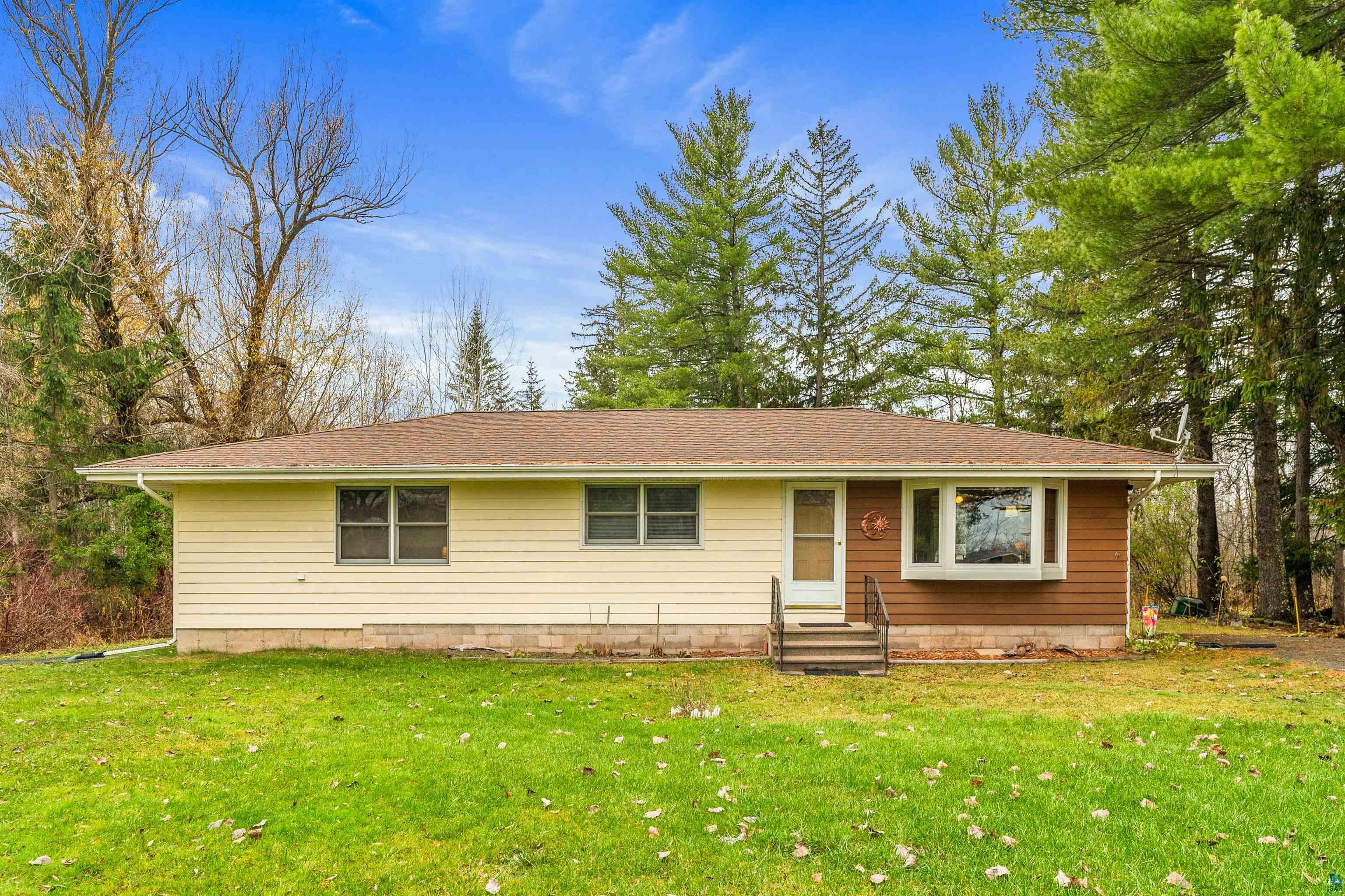 Single story home featuring a front lawn