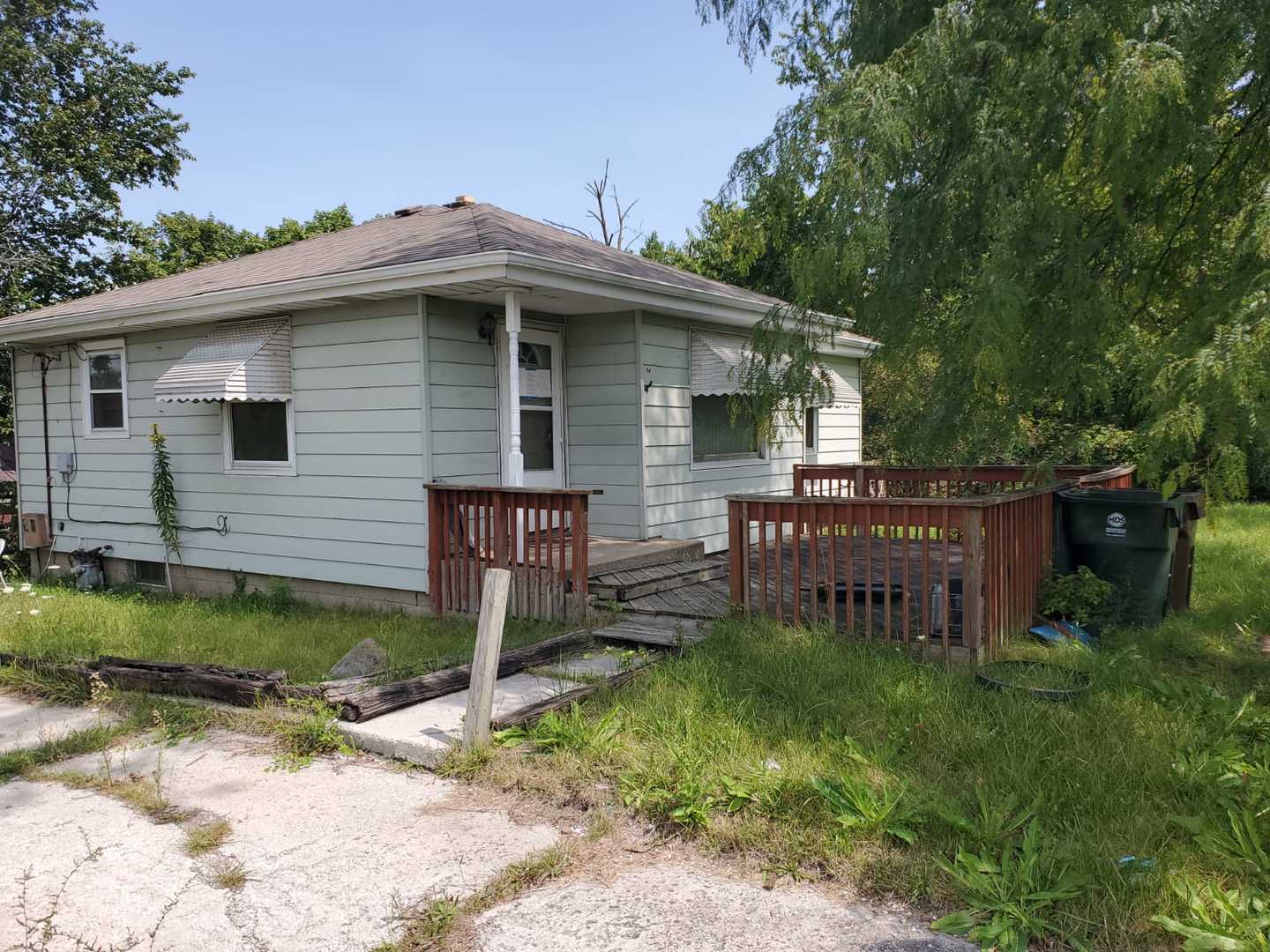 a view of a house with a yard and sitting area