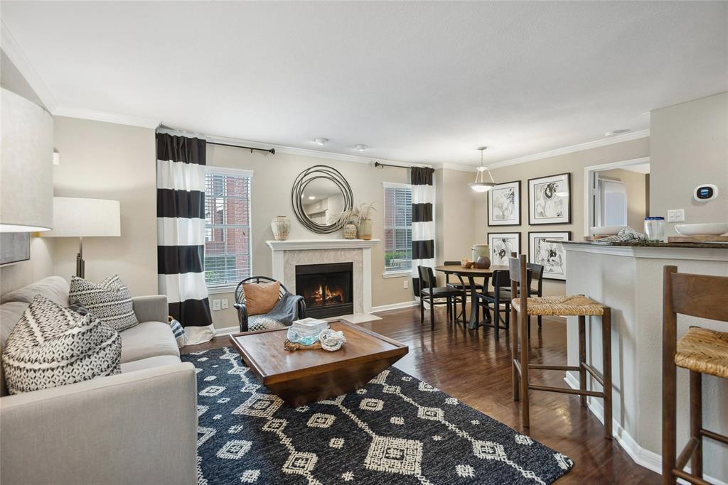 a living room with furniture a fireplace a clock and a window