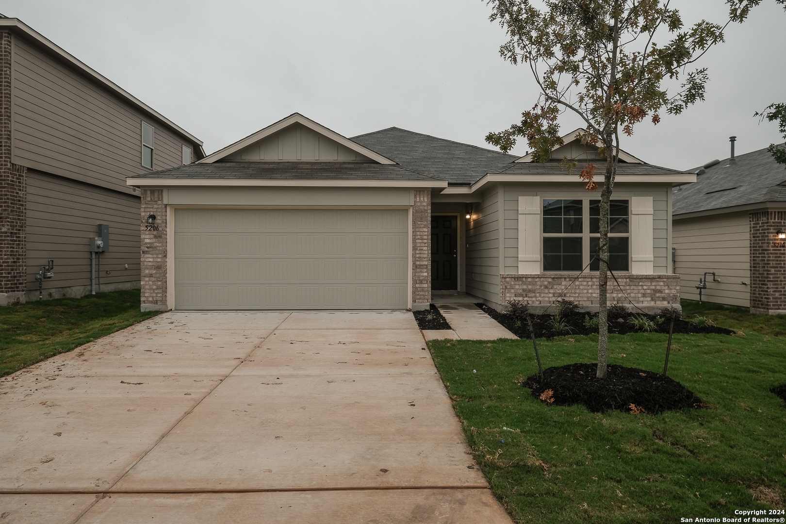 a front view of a house with a yard and garage